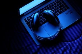 headphones on Laptop keyboard, blue and black