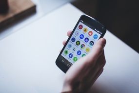 smartphone in man's hand on the table