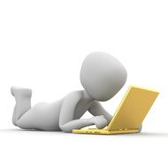 lying figure behind a laptop