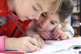 children draw in notebook