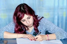 girl writing in the notebook