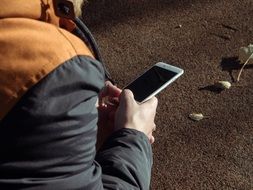 man sitting with white IPhone 6