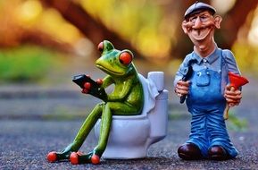 plumber and frog on the toilet