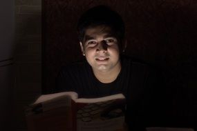 man with a book in the dark