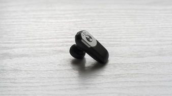 black Handsfree Earphone at grey surface