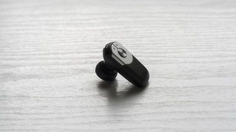 black Handsfree Earphone at grey surface