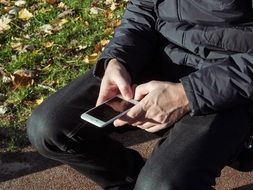 man sitting with Iphone 6S Plus