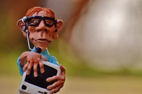 clay figurine of a man with a computer