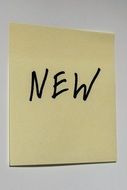 sticky note with the word "new"
