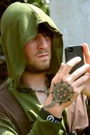 man in hoody with smartphone