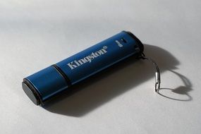 blue usb stick on a white table