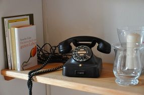 vintage telephone on a bookshelf