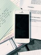 smartphone on pile of papers