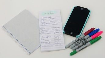 metal list the smartphone and multi-colored pens