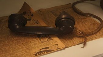 telephone receiver on an old newspaper