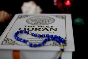 the Holy Quran book and rosary