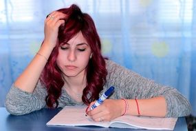 student writing in the notebook
