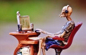 skeleton at the computer desk