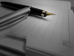 ink pen lies on a notebook