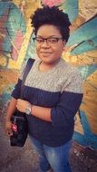 African student against the background of the wall with graffiti