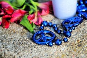 blue necklace near flowers