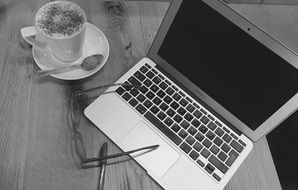 Laptop and Coffee on desk, top view