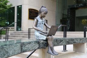 child Girl with Laptop sitting on bench, sculpture