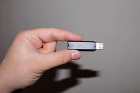 black flash drive in hand