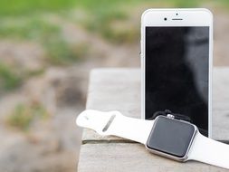 Iphone and Iwatch on the wooden bench