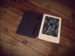 tablet in leather cover and pen