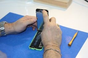 Man repair phone in repair center