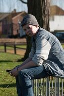 teenager with a cellphone in the park