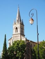 vintage street Lantern in front of aged Church, france, Bonnieux