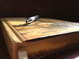 pen on thick notebook close up