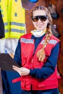 girl in goggles with a folder close up