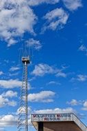 communication tower under the blue sky with clouds