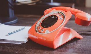 vintage orange telephone on the table