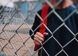schoolboy behind the fence ne