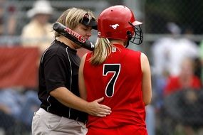 coach with a player in softball