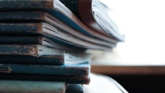 a pile of books on the library table