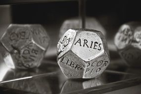 the signs of the zodiac carved on the metal cubes