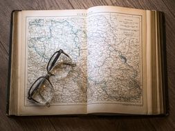 glasses on the map in the book