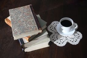 old books and cup of black coffee