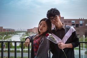 asian couple in love with red rose