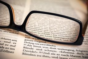 glasses lie on an open book