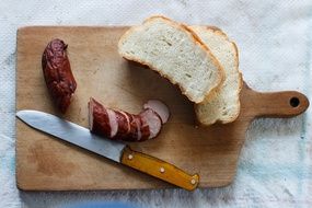 sausage and bread on the cutting board