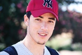 portrait of a young man in a red cap