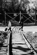 woman and child boy crossing railway, Black and White