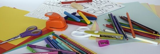 paper, scissors, Felt Tip Pens and Colored Pencils on desk