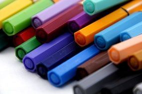 multi-colored markers are in the pile